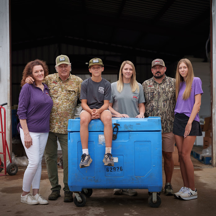 Three generations of family-owned business Louisiana Crawfish Company standing in front of their warehouse.