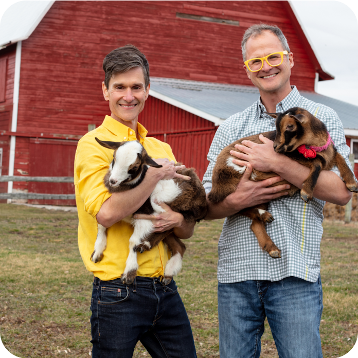 Two founders of Beekman 1802 holding baby goats on a farm with the stat showing a 400% increase in ROI.