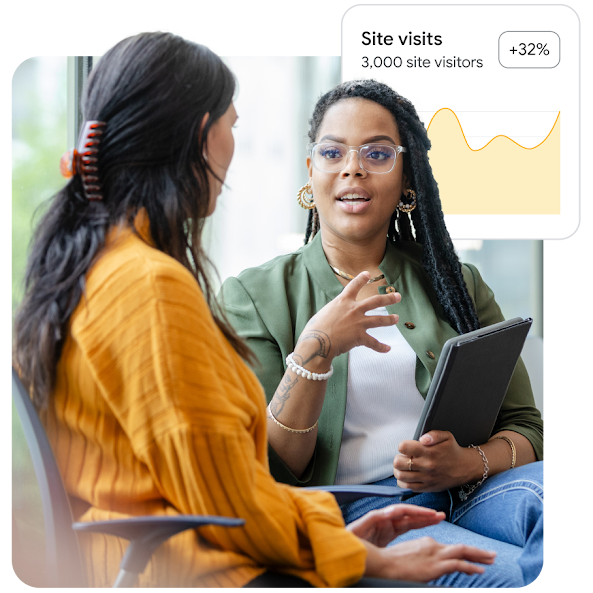  Two colleagues chatting over a tablet and UI of a line graph showing an increase in site visitors.