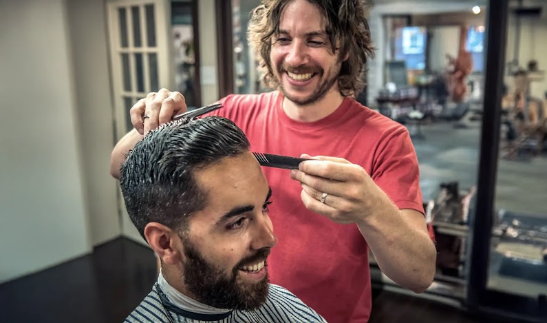 Photo of a barber giving a man a haircut